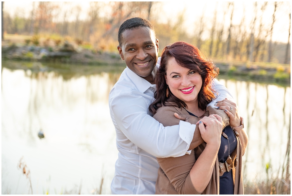 gene hugging ashley from behind during their anniversary session