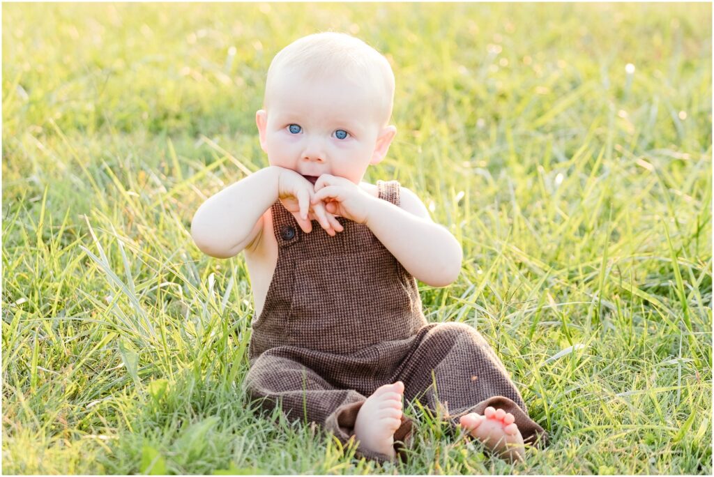 baby with hands in mouth for one year portraits