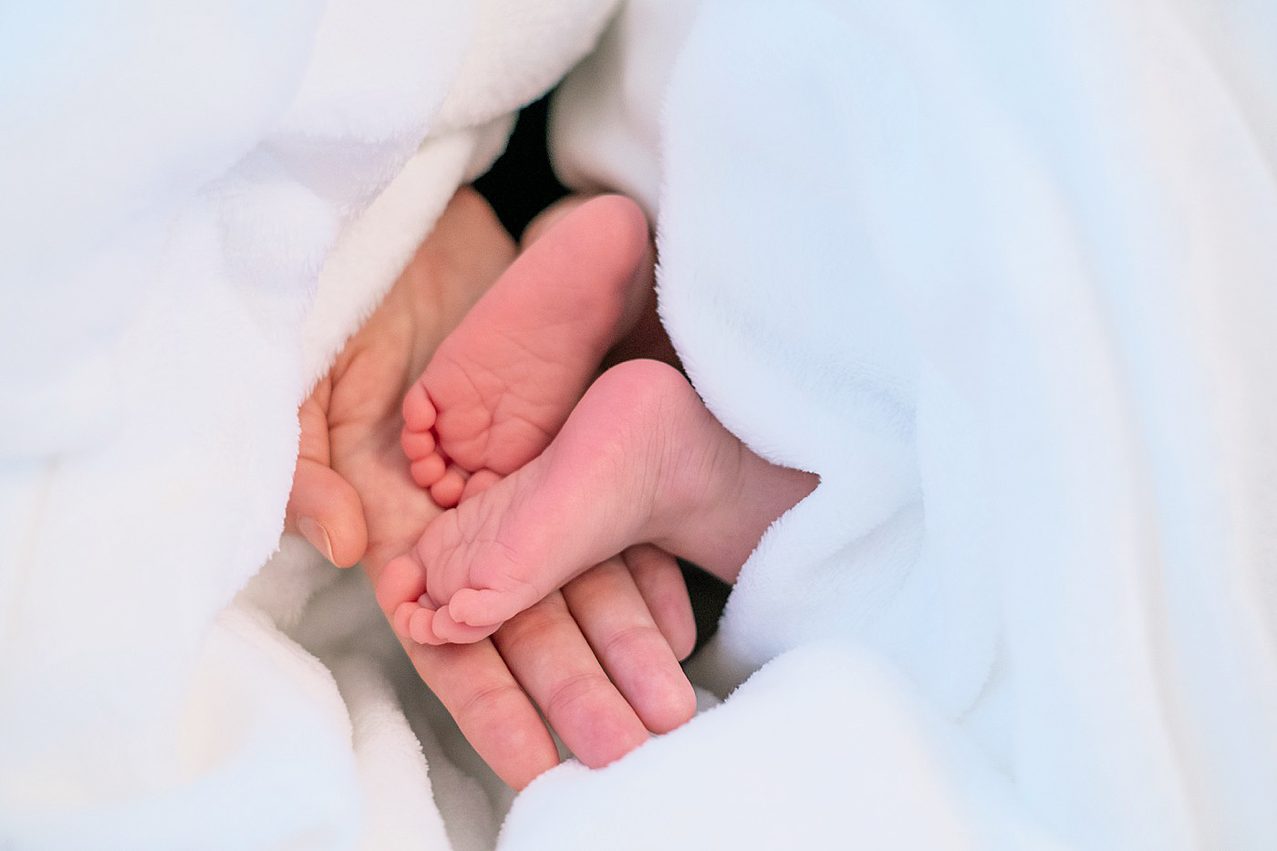 tiny feet in mom's hand