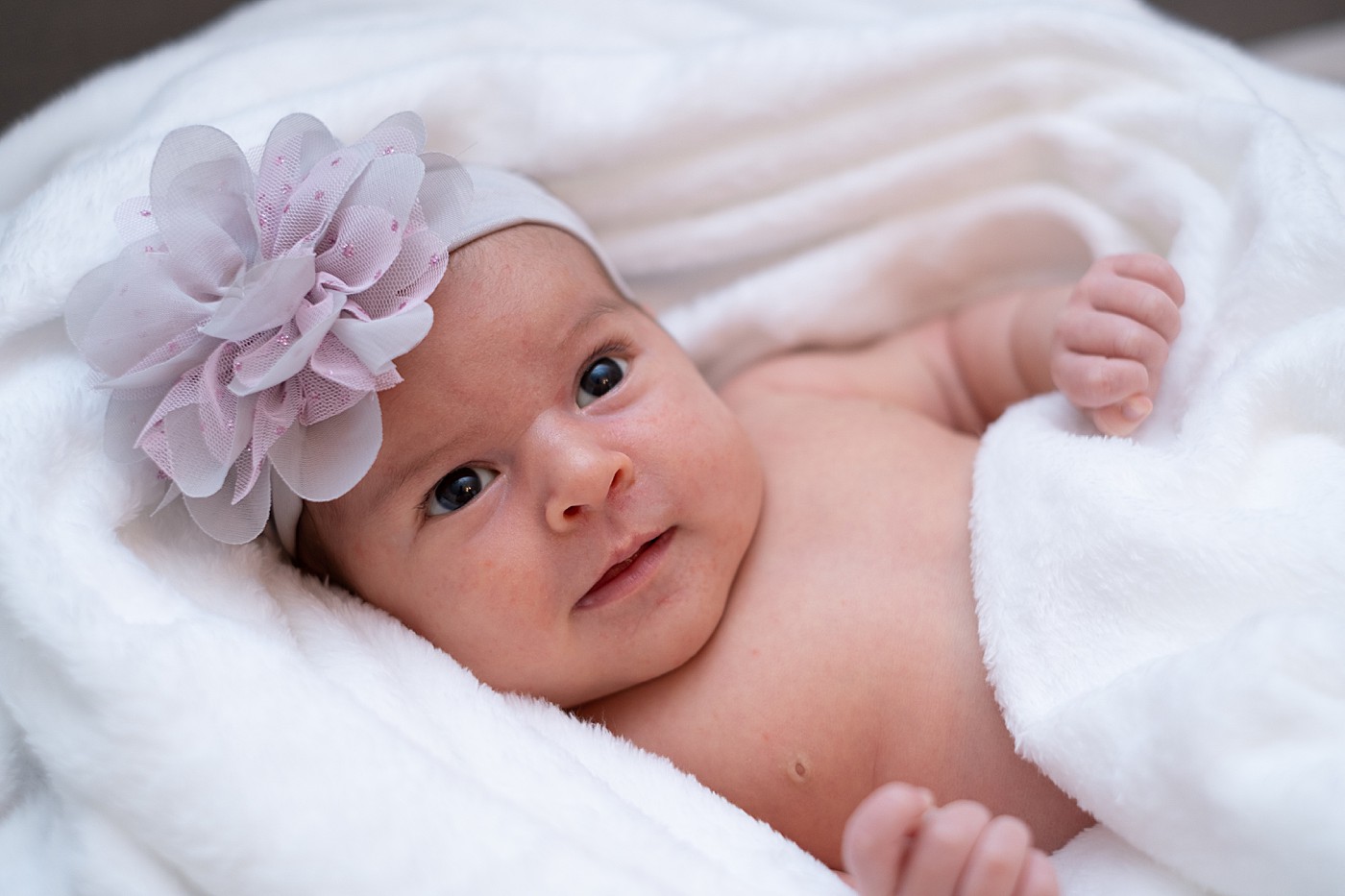 close up baby portraits with flower bow