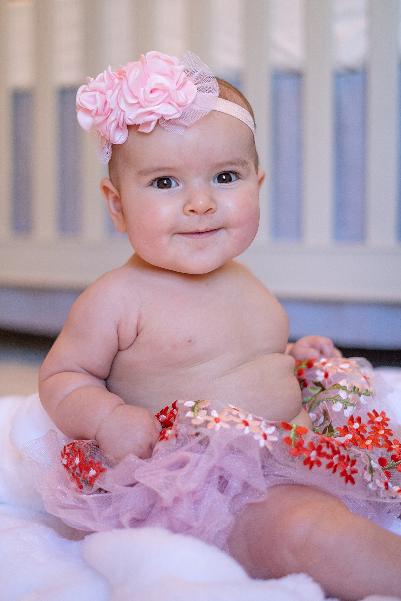 baby in a tutu smiling at camera