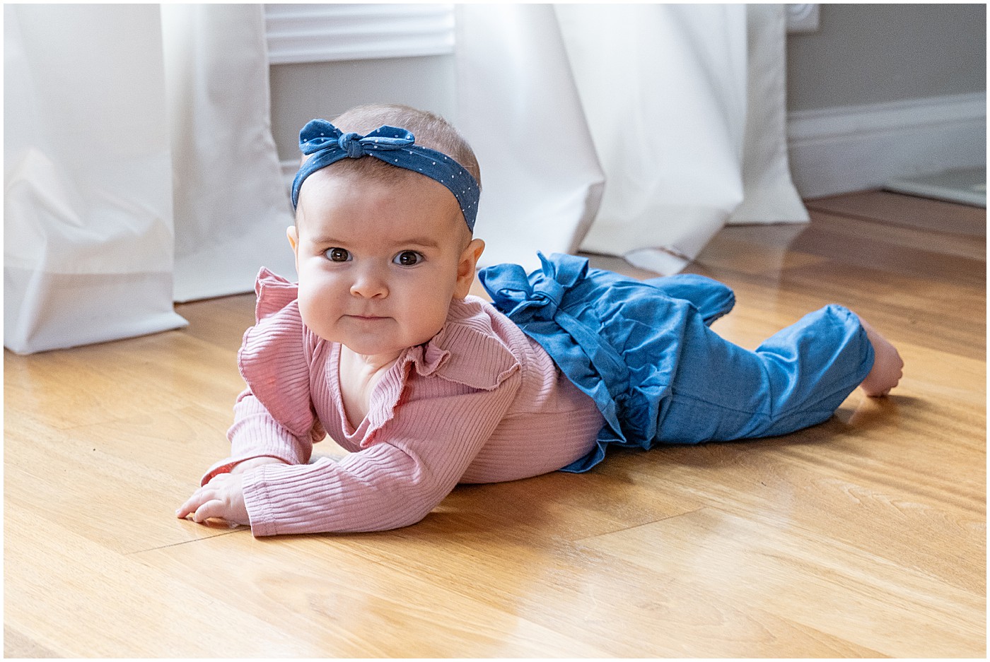 baby laying on belly during first autumn portraits