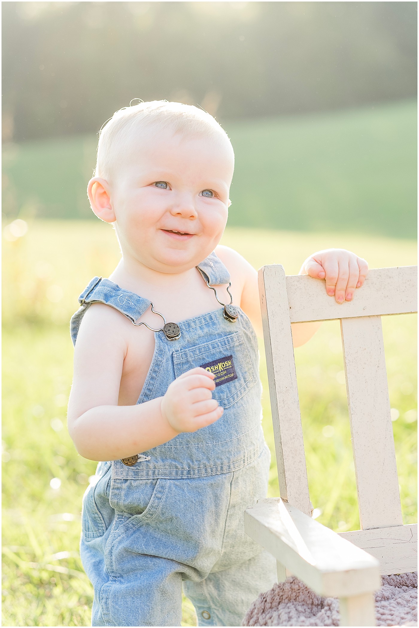 one year old boy in overalls on his portrait session