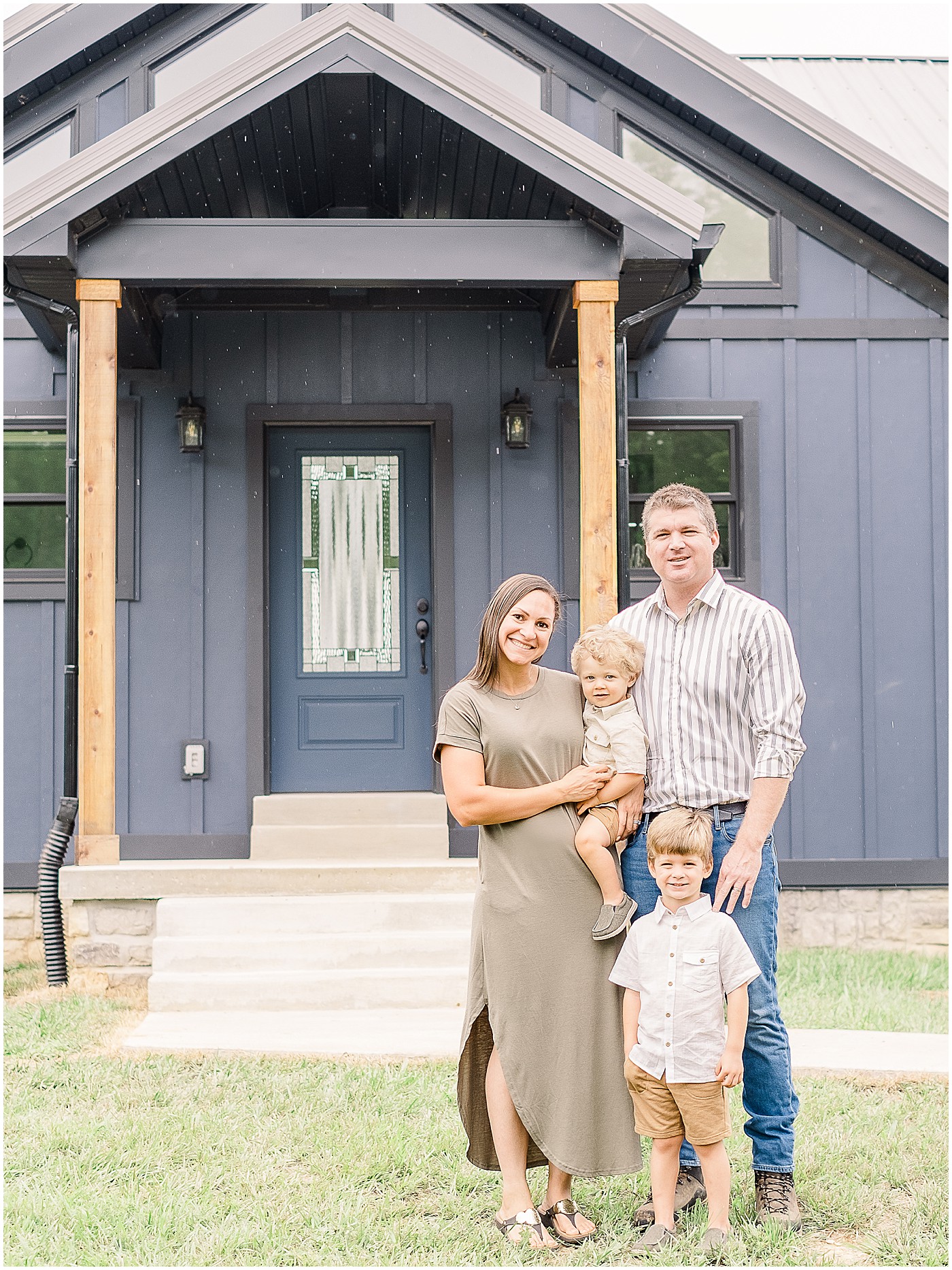 family portraits in front of the new farmhouse