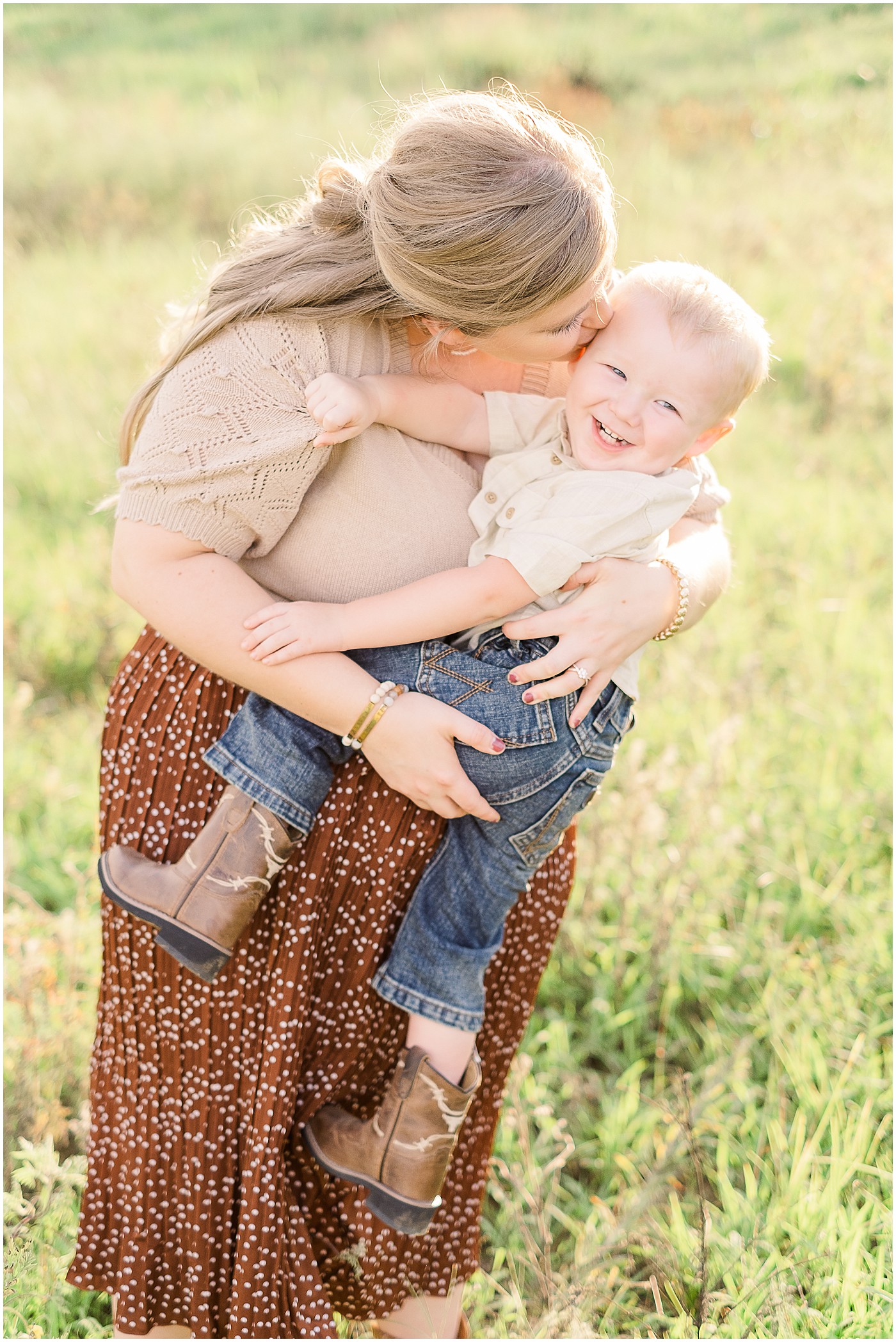 momma kissing her little boy during pregnancy announcement photos