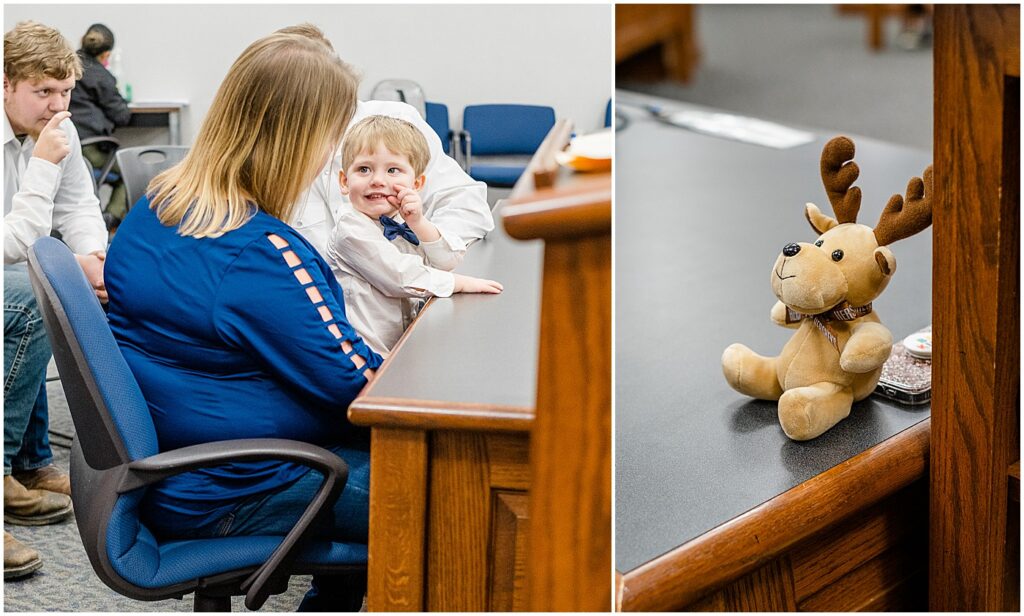 sitting on mommy's lap with a toy on the desk