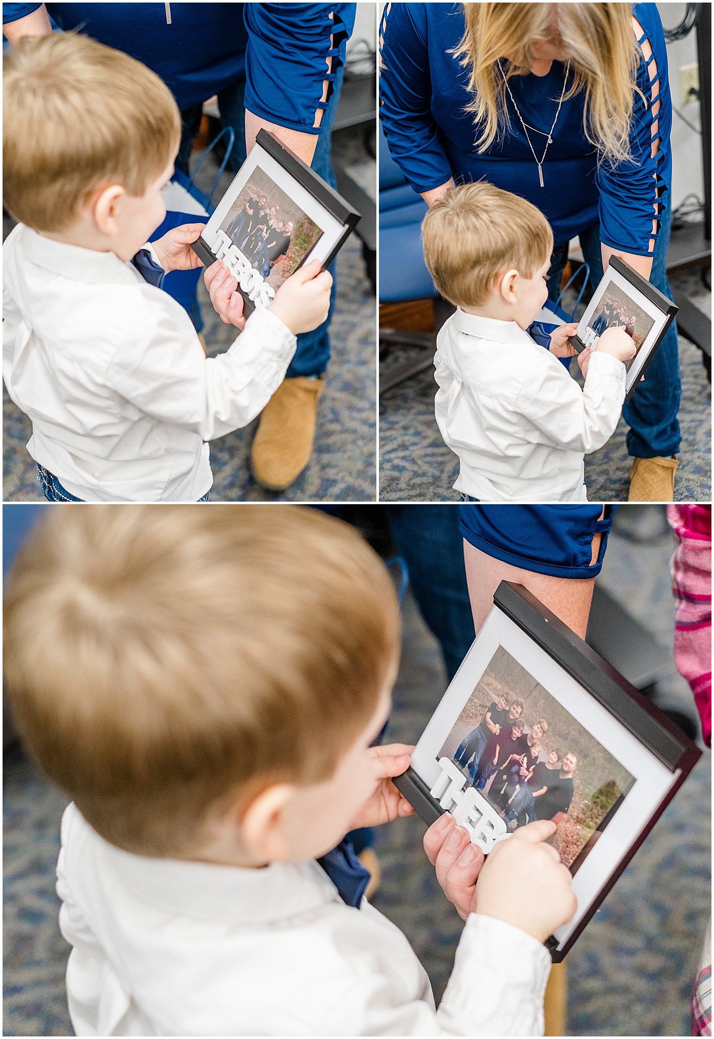 The youngest of seven boys looking at a framed pic of all the sons