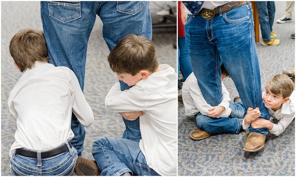 two of the seven boys riding on the legs of the oldest son