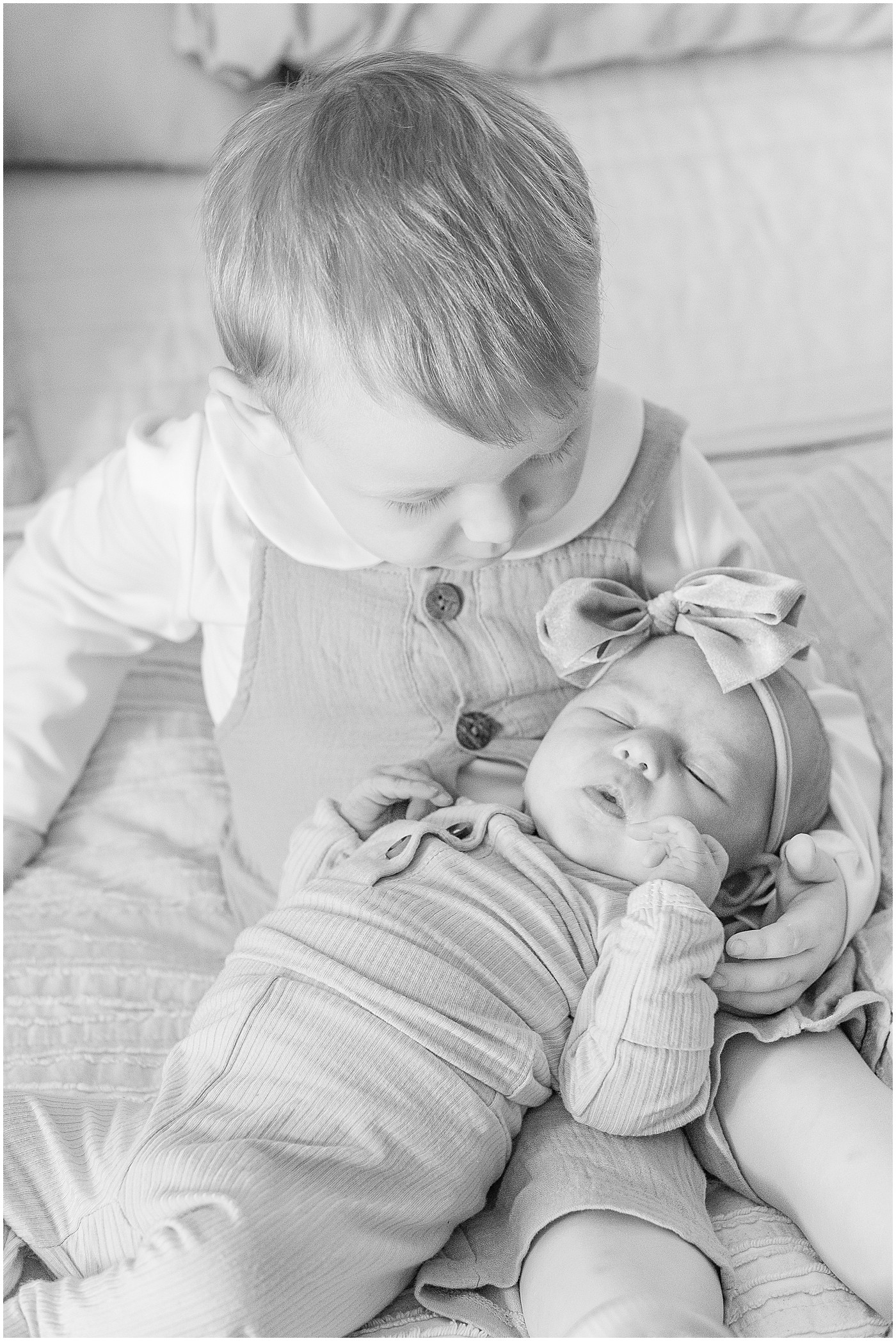 black and white photo of siblings during newborn session