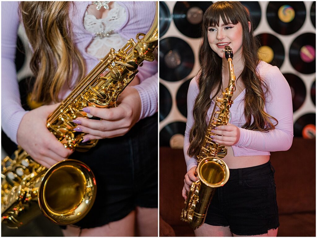 girl with saxophone in front of records on the wall