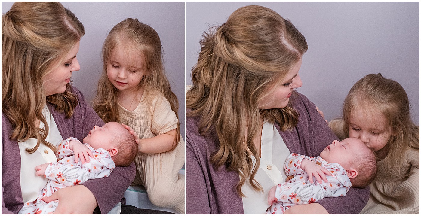 mommy holding baby and big sister kissing baby's forehead