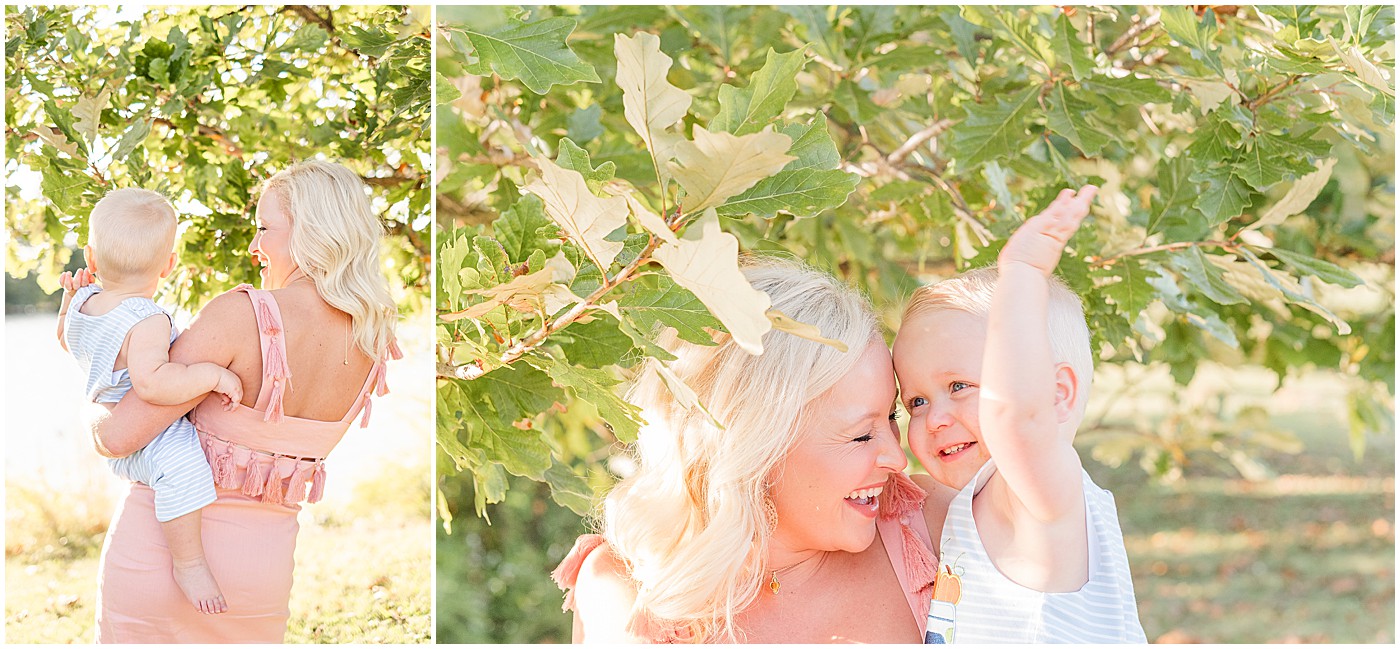 a mother and son playing in the leaves