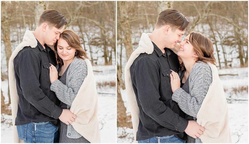 cuddling under a blanket for engagement photos