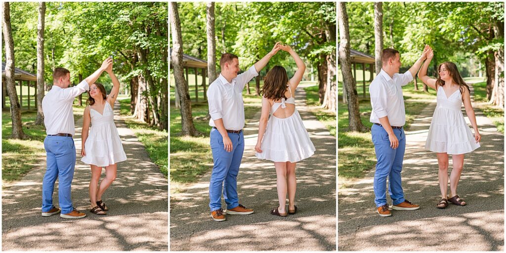 a man in blue pants twirling his fiancee in a white sundress