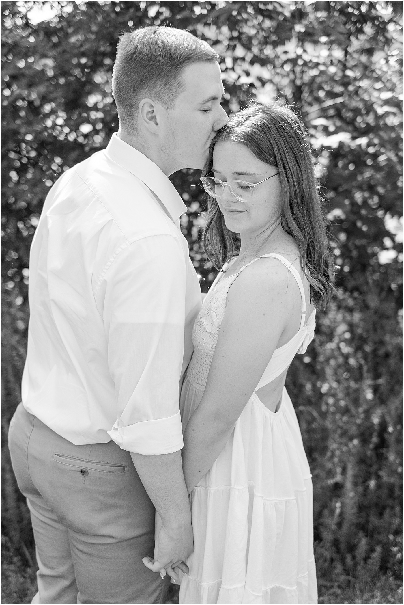 man kissing his fiancee on top of the head during their engagement session in Glasgow, KY