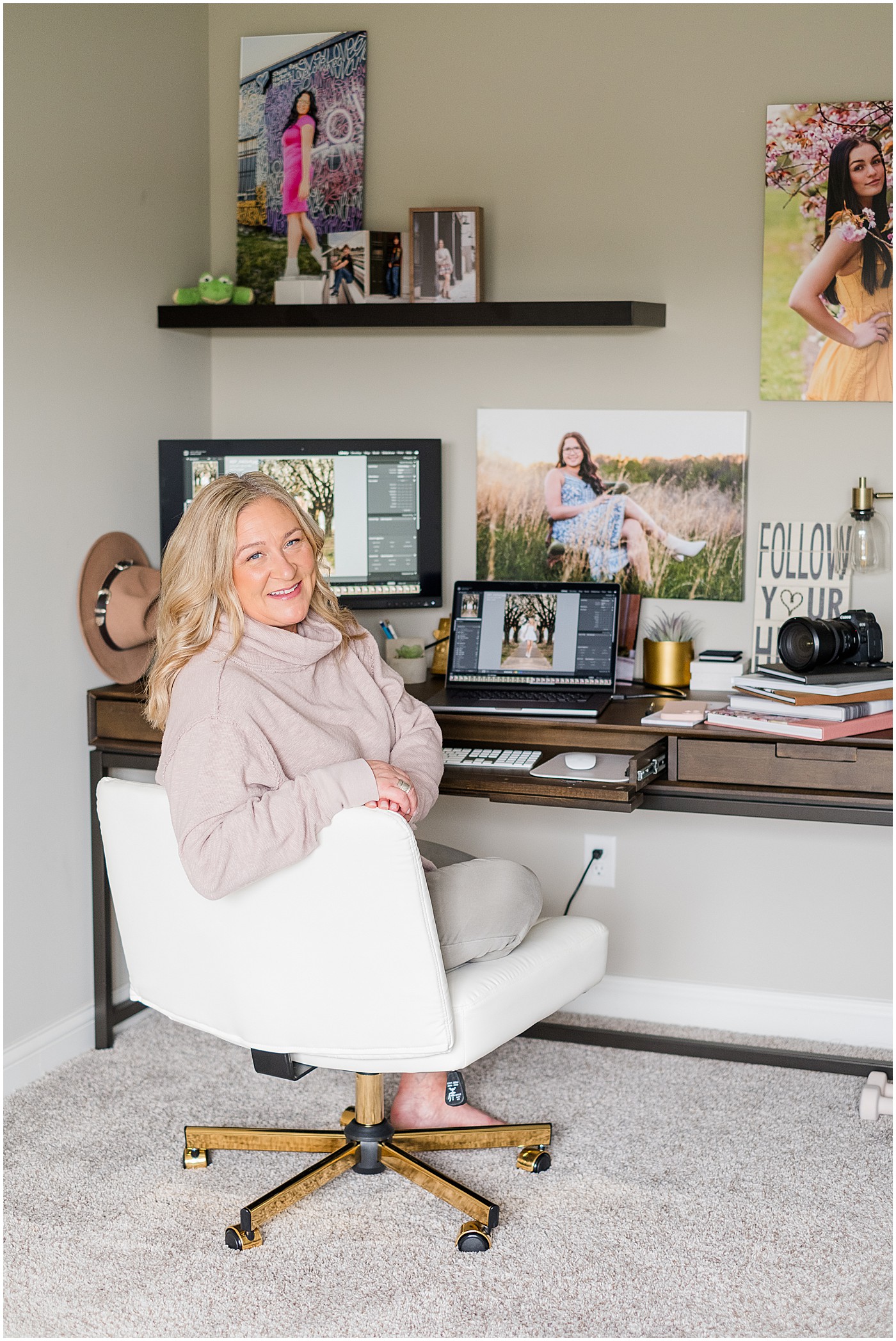 full length photo of photographer sitting at her desk