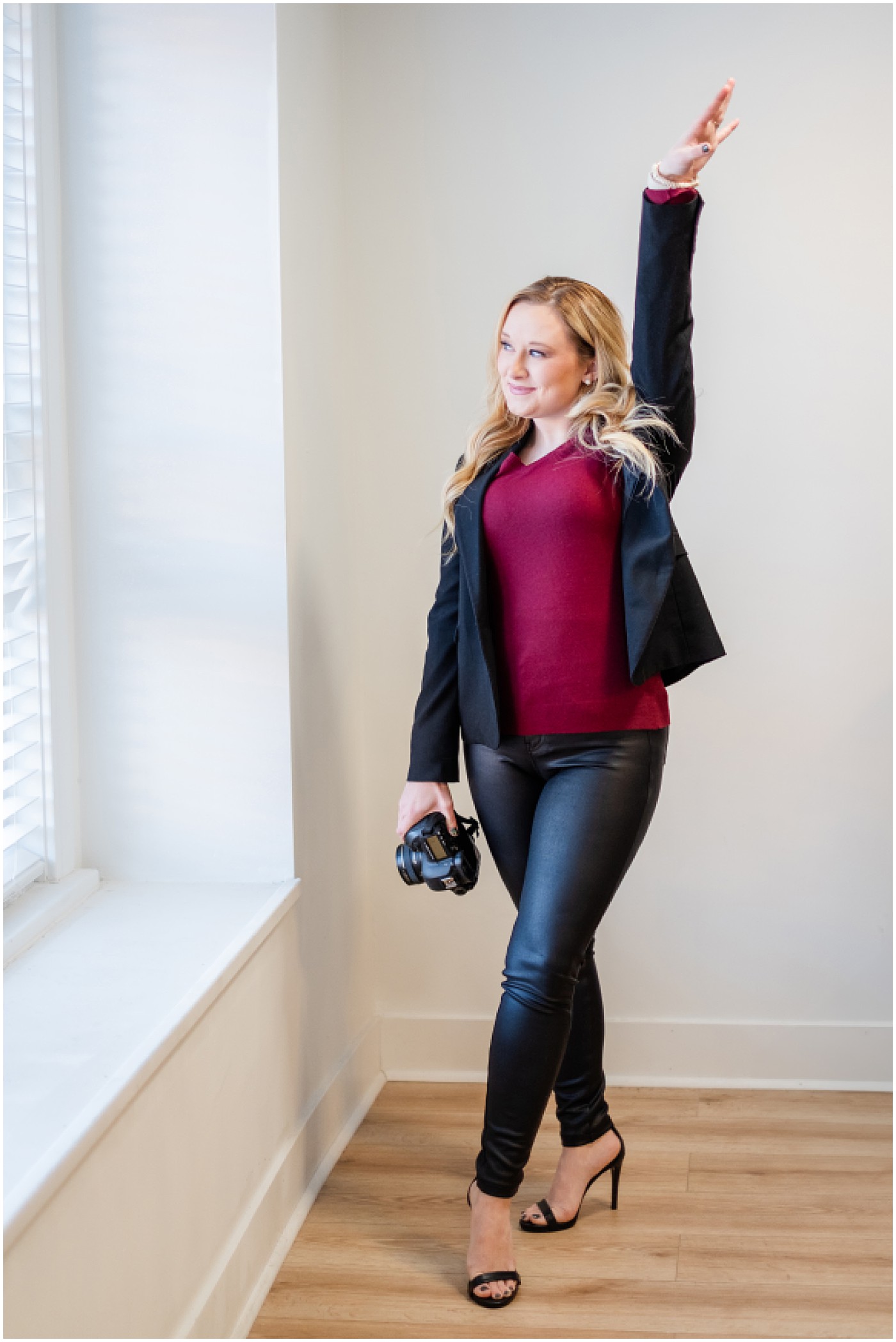 a photographer cheering while holding her camera