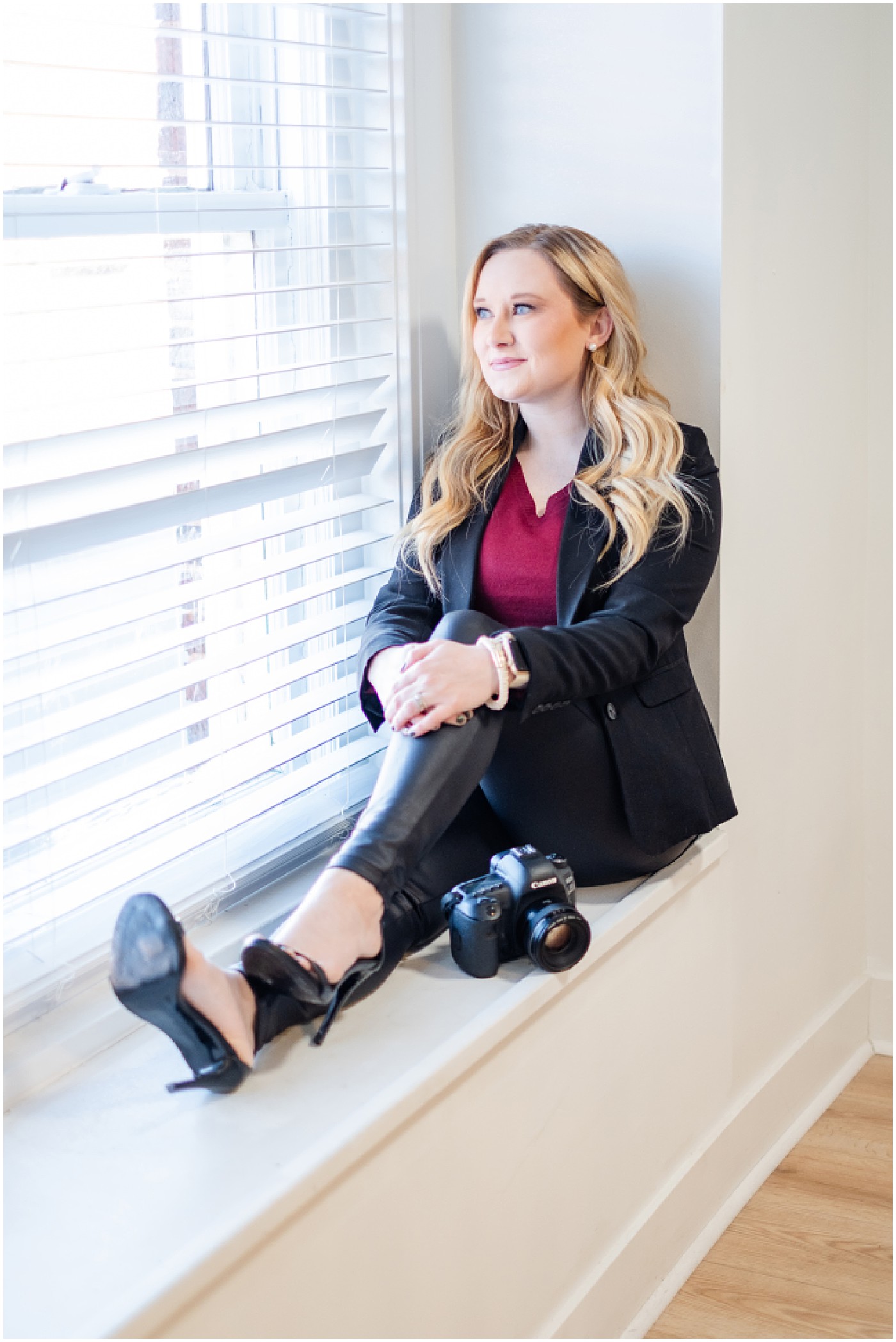 photographer sitting by window with her camera