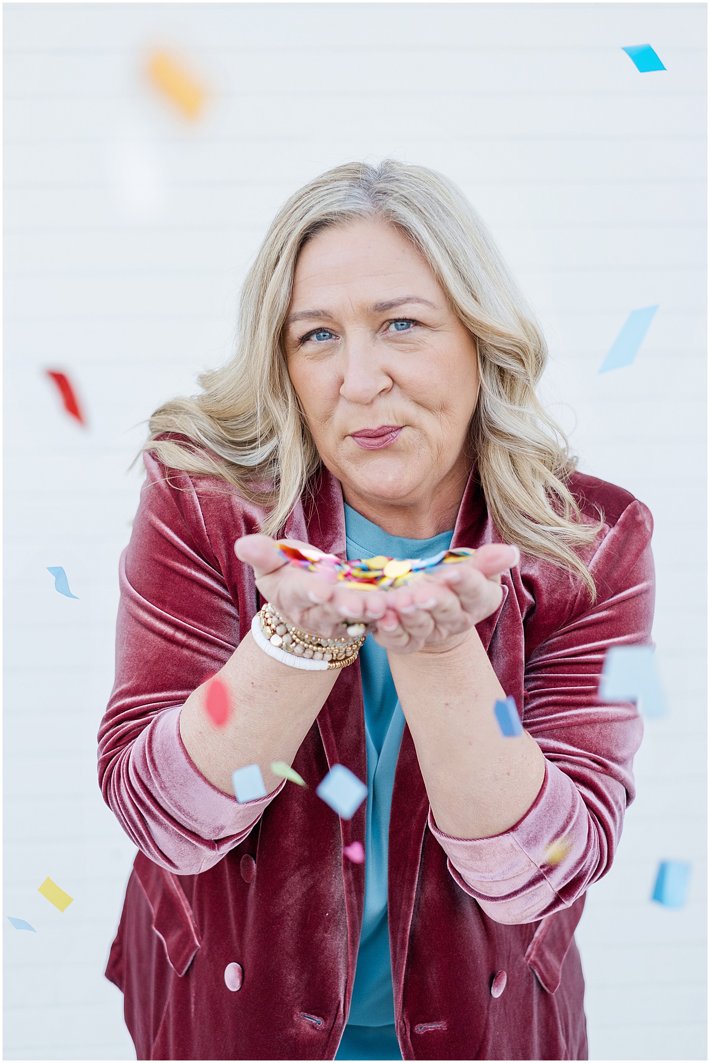 photographer blowing confetti on her photography branding session