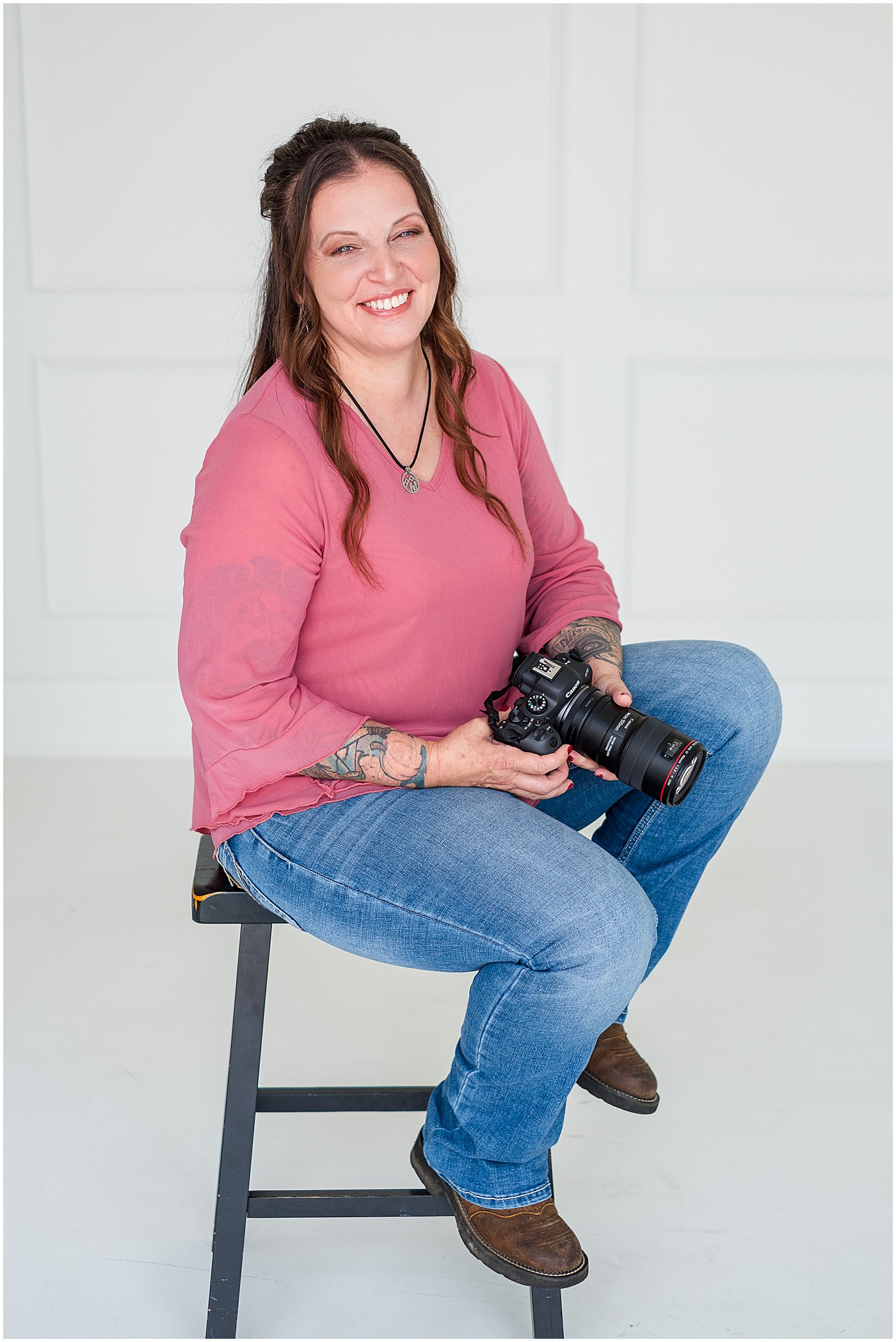 Lexington photographer sitting on a stool with her camera on her photography branding session