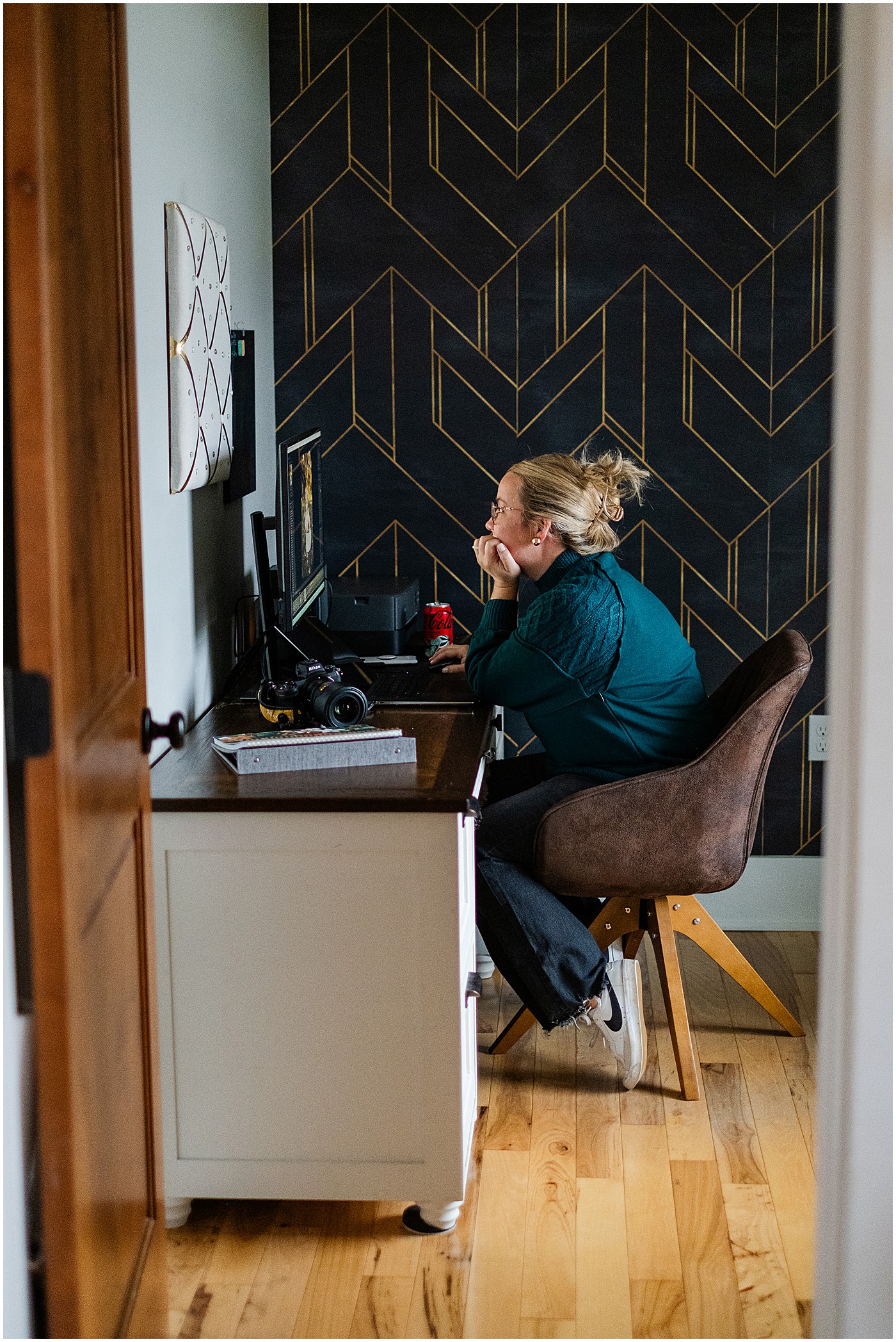 photographer editing at her desk during a photography branding session