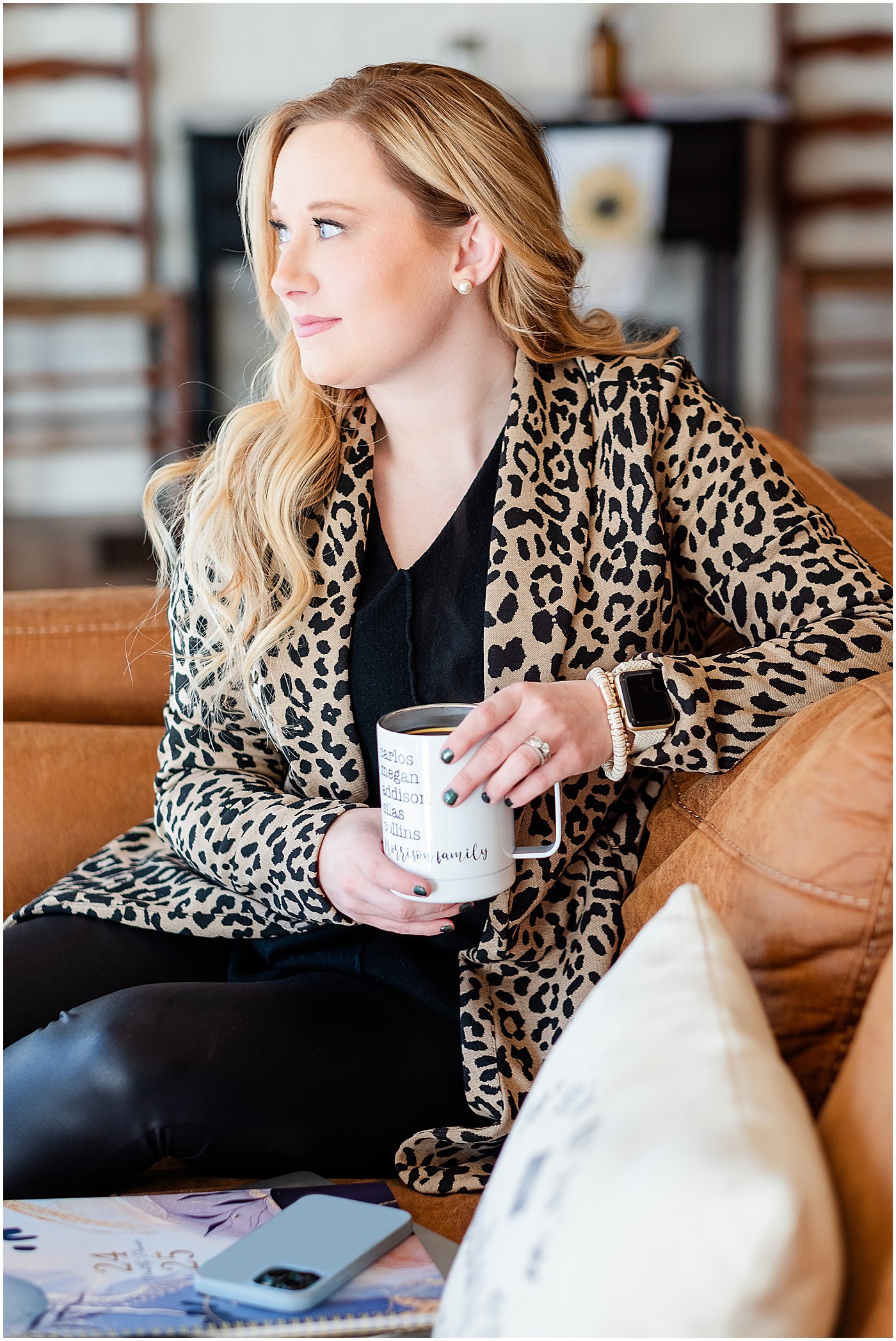 photographer holds a coffee mug with her kids names on it during photography branding session