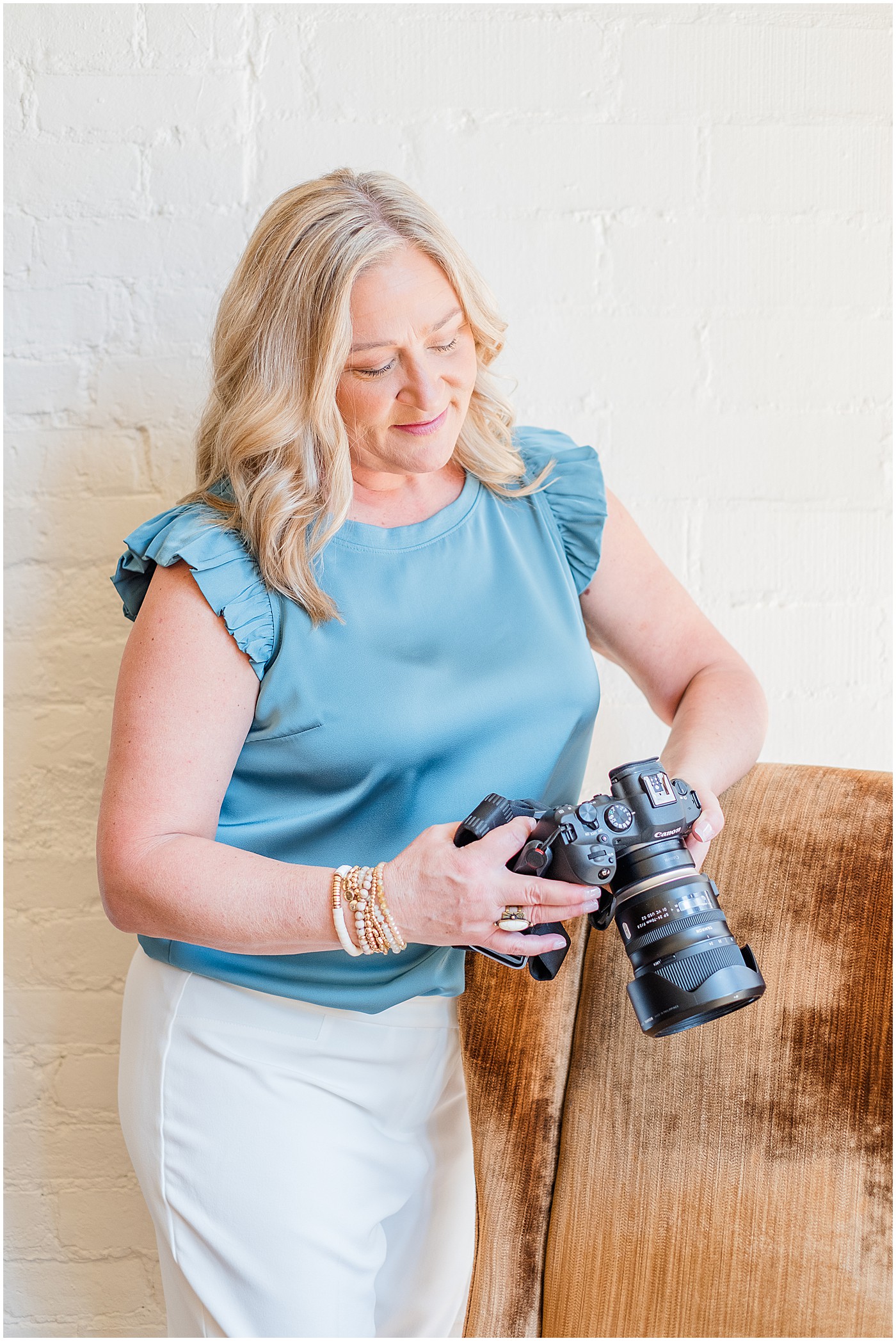 photographer looking down at her camera during photography branding session