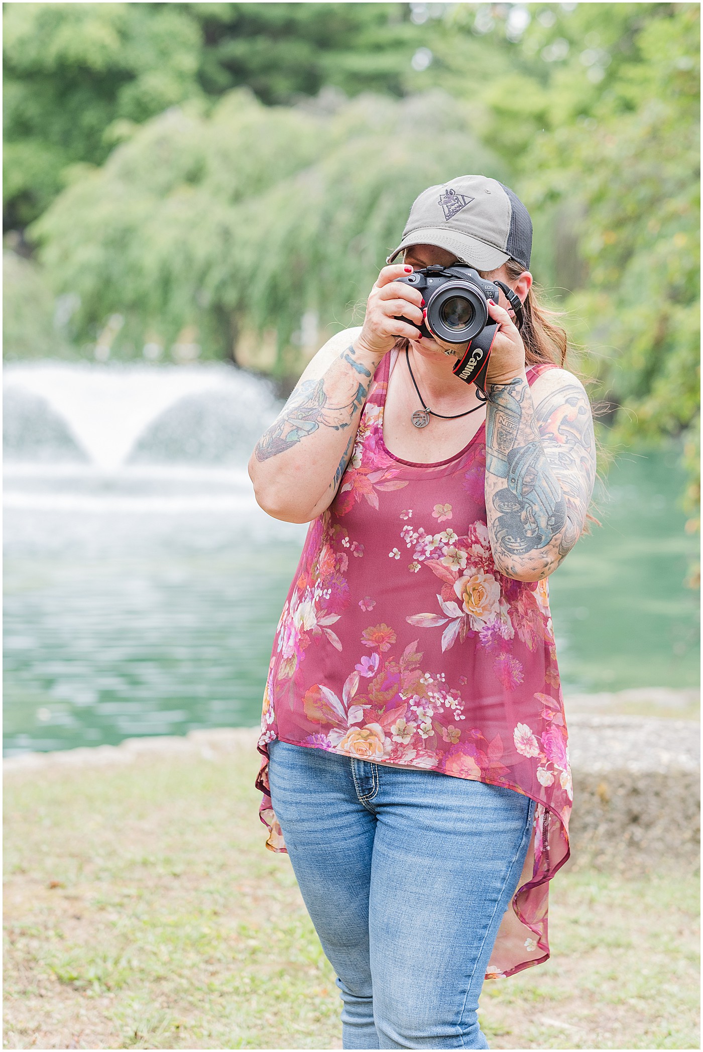 photographer looking through her camera outside on photo session