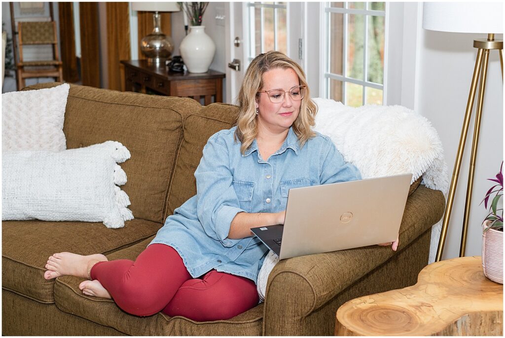 photographer sitting comfortably on couch editing on laptop