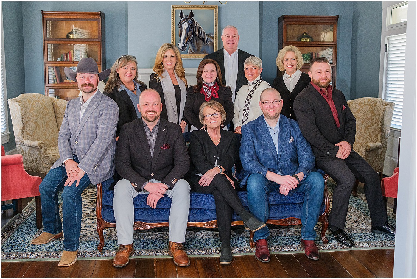 real estate team posing on a couch