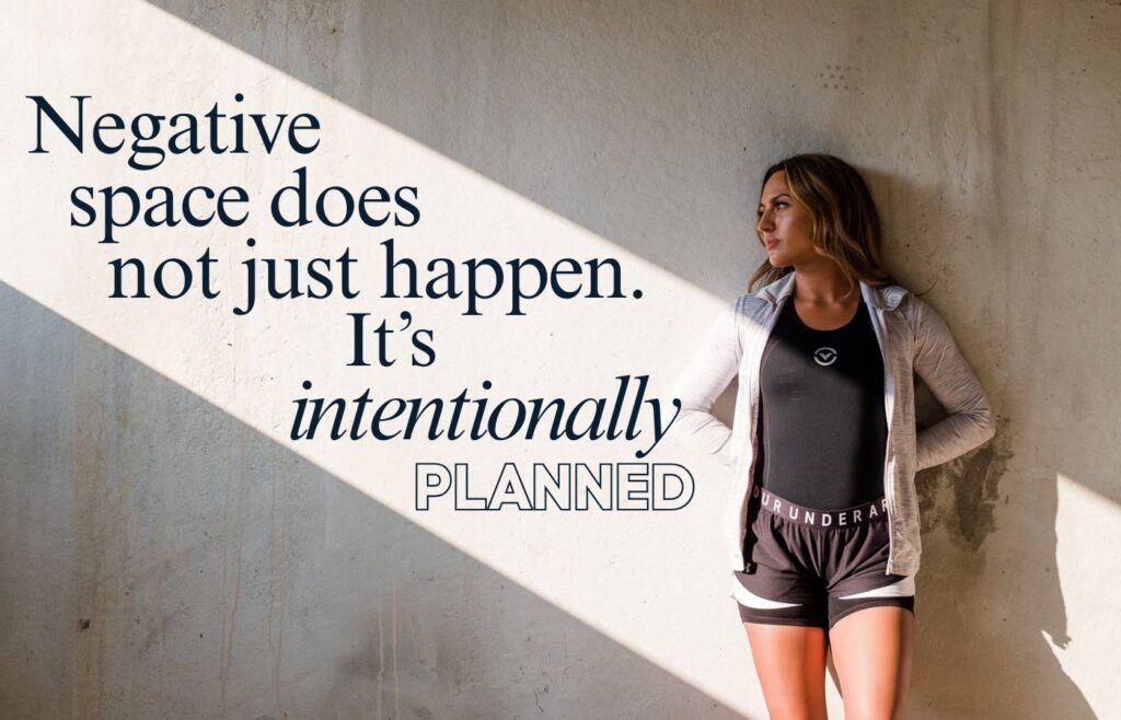 an image with negative space to show you need to plan photos intentionally to attract better clients. A girl workout clothes standing in a beam of light.