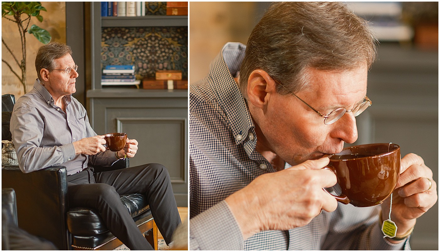 man drinking tea while watching passersby